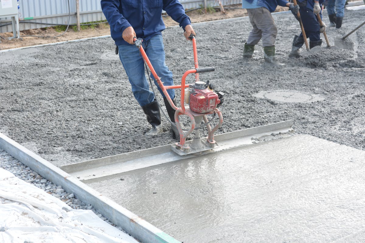 Fresh concrete driveway pad being finished